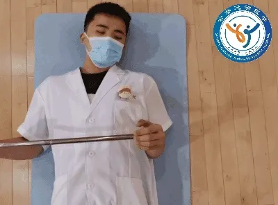 Supine stick-assisted external rotation
